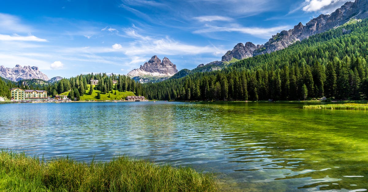 Are Italian Dolomites different in landscape and experience compared to Austrian Tyrol region? - Green Trees Near Lake Under Blue Sky Are Italian Dolomites different in landscape and experience compared to Austrian Tyrol region? - Green Trees Near Lake Under Blue Sky