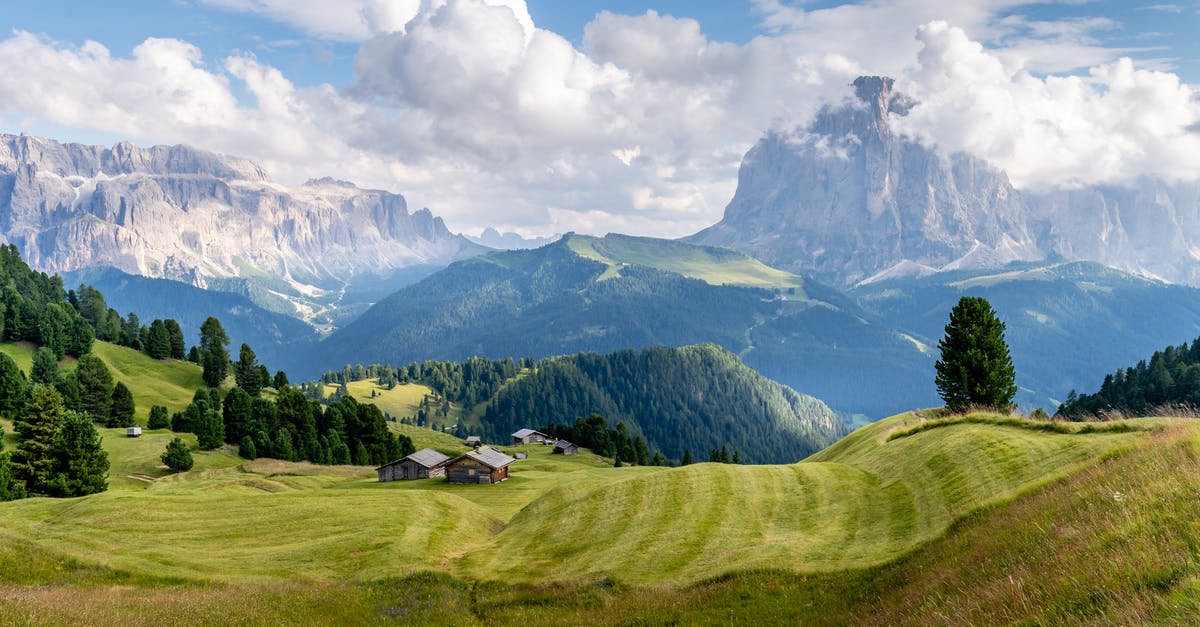Are Italian Dolomites different in landscape and experience compared to Austrian Tyrol region? - Green Grass Field Near Mountains Under White Clouds And Blue Sky Are Italian Dolomites different in landscape and experience compared to Austrian Tyrol region? - Green Grass Field Near Mountains Under White Clouds And Blue Sky