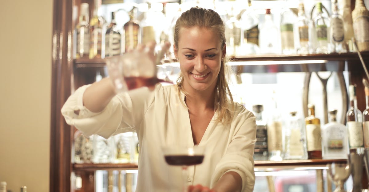 Are izakaya where the bartender doesn't stand opposite the bar inauthentic? - Cheerful female bartender pouring cocktail in bar Are izakaya where the bartender doesn't stand opposite the bar inauthentic? - Cheerful female bartender pouring cocktail in bar
