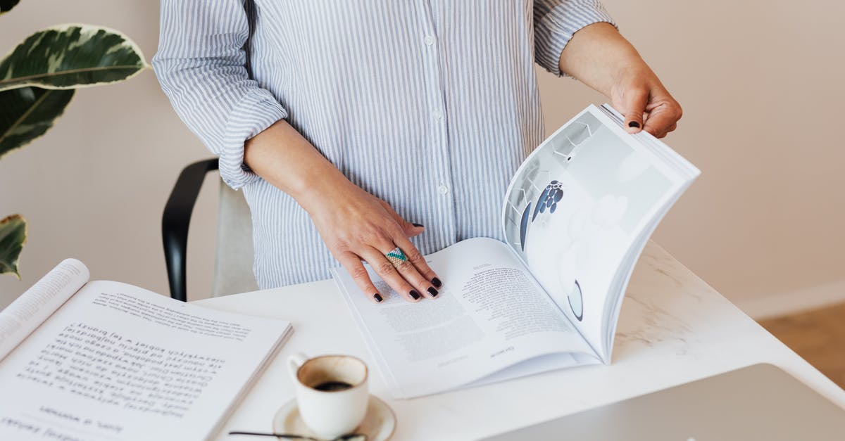 Are original documents for the short-term study visa are also not required anymore? - Crop unrecognizable female in light blue shirt standing near desk with laptop and opened book while reading professional journal and enjoying cup of aromatic coffee