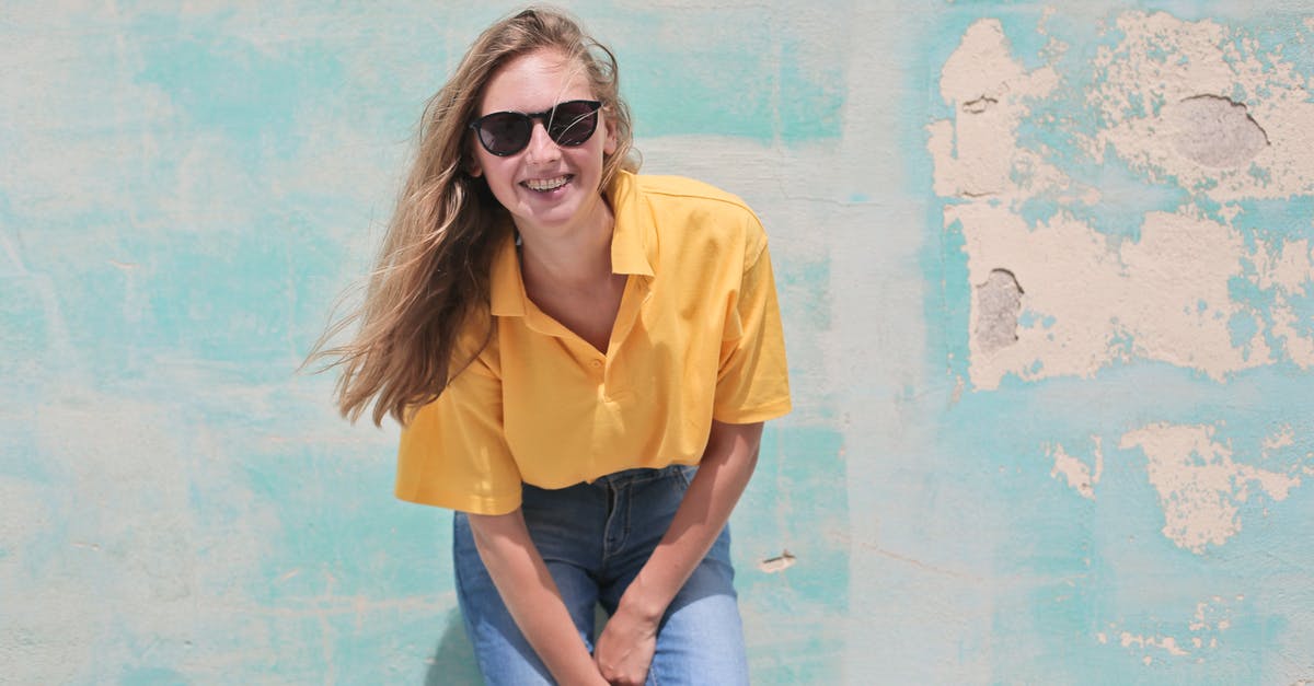 Are people wearing bright blue clothes considered gay in Russia? - Woman Wearing Yellow Polo Shirt Standing in Front of Teal Concrete Wall Are people wearing bright blue clothes considered gay in Russia? - Woman Wearing Yellow Polo Shirt Standing in Front of Teal Concrete Wall