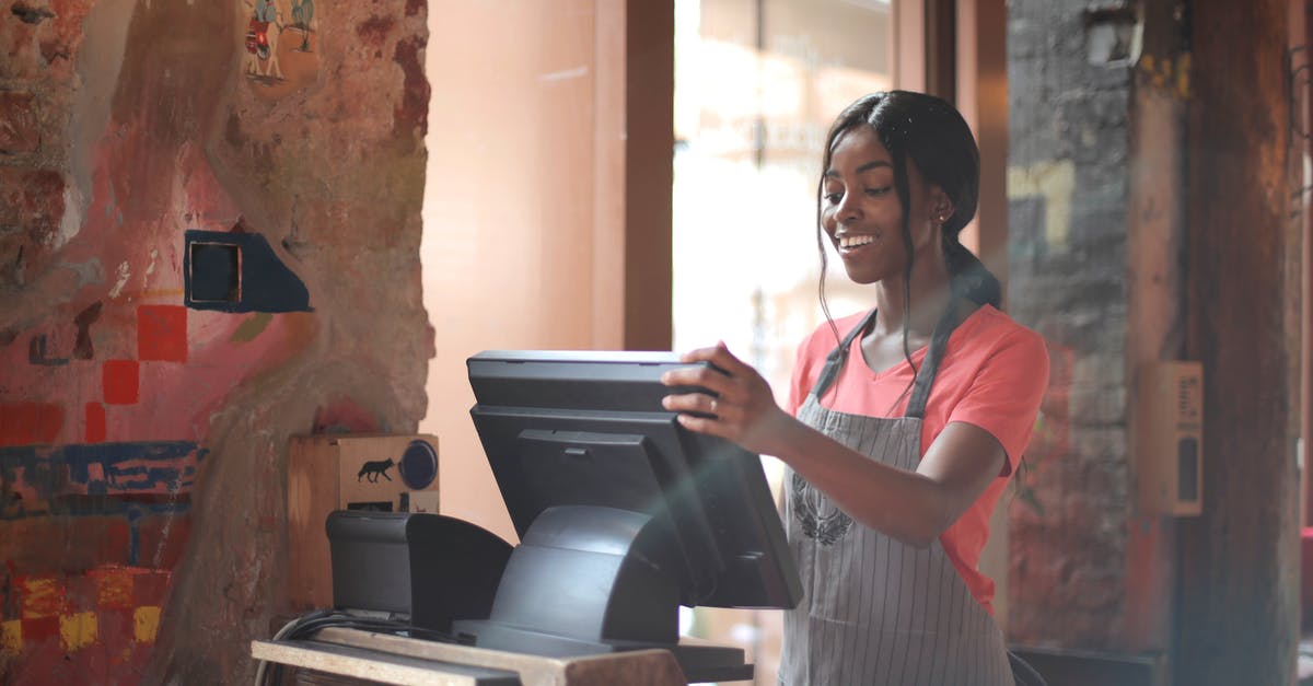 Are street numbers in addresses in geographic order in Taiwan? - Cheerful American African waitress in apron working on counter monitor while registering order at cozy cafe Are street numbers in addresses in geographic order in Taiwan? - Cheerful American African waitress in apron working on counter monitor while registering order at cozy cafe