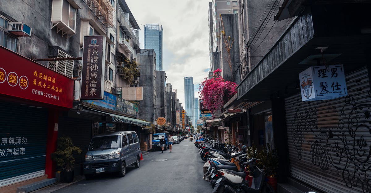 Are Taiwan car rental prices really that high? - Photograph of Cars and Motorcycles Parked Between Buildings Are Taiwan car rental prices really that high? - Photograph of Cars and Motorcycles Parked Between Buildings