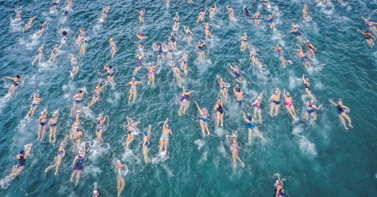 Are the beaches in Rosarito Mexico clean enough for swimming? - Drone view of swimmers in ocean water during race competition in tropical country Are the beaches in Rosarito Mexico clean enough for swimming? - Drone view of swimmers in ocean water during race competition in tropical country