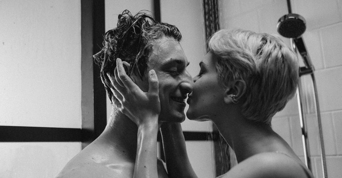 Are there any airports in the world which offer shower facilities for everyone? [closed] - Grayscale Photo of Woman and Man