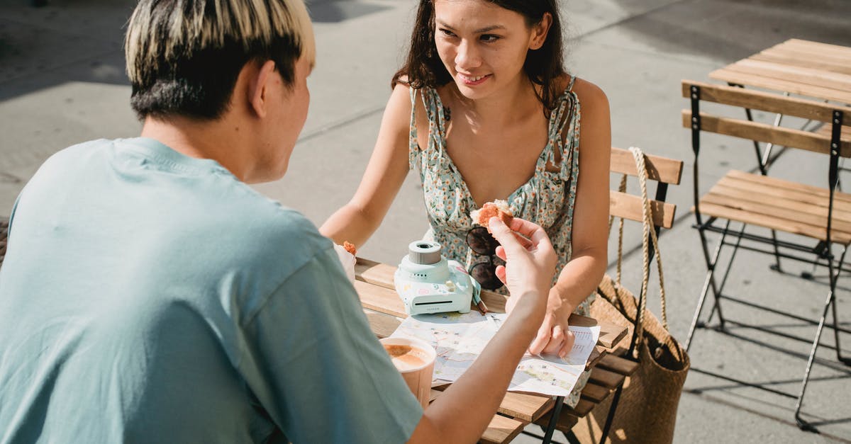 Are there any issues with speaking Spanish as a tourist in Portugal? - Smiling ethnic woman talking to unrecognizable boyfriend in street cafeteria Are there any issues with speaking Spanish as a tourist in Portugal? - Smiling ethnic woman talking to unrecognizable boyfriend in street cafeteria