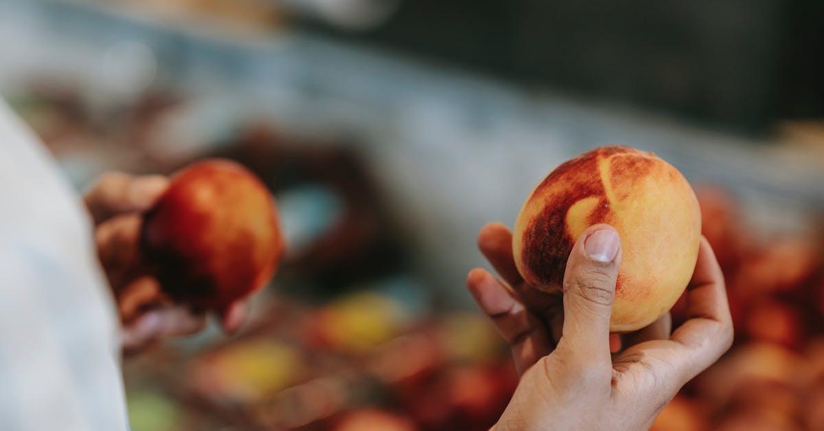 Are there any local shops to buy/eat shortbread in Edinburgh? [closed] - Crop faceless male choosing peaches in food market