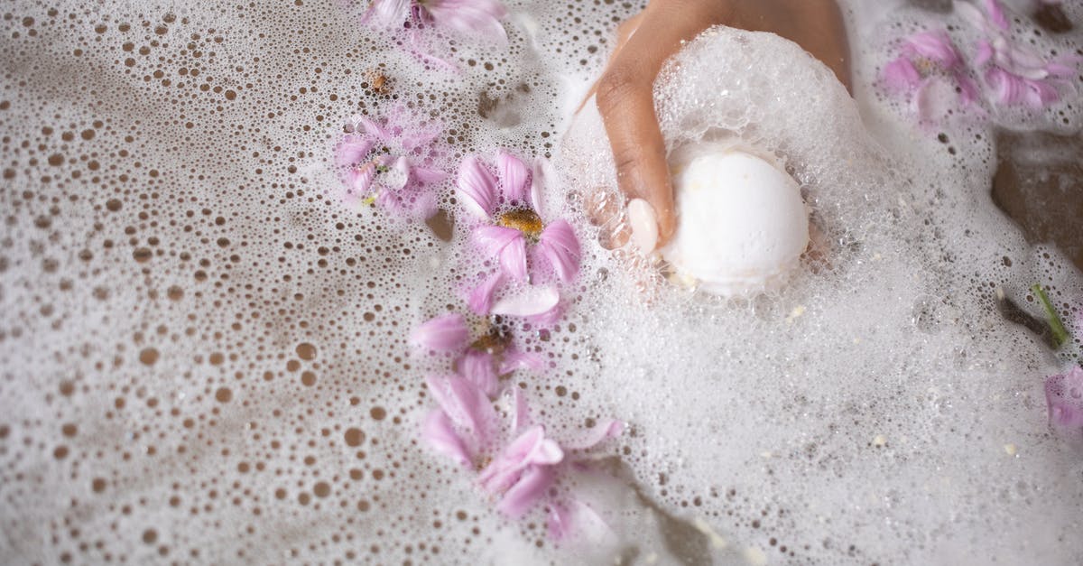 Are there any restrictions for bath salts (magnesium flakes) in hand luggage flying within Europe? - Woman holding ball of bath salt in water with foam and flowers Are there any restrictions for bath salts (magnesium flakes) in hand luggage flying within Europe? - Woman holding ball of bath salt in water with foam and flowers