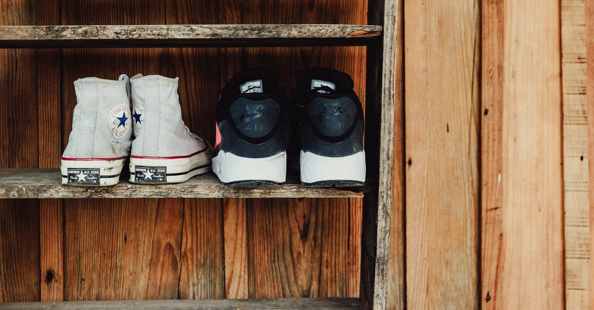 Are there any restrictions in carrying shoes in cabin baggage? - Two Pairs of Gray and Black Sneakers on Rack Are there any restrictions in carrying shoes in cabin baggage? - Two Pairs of Gray and Black Sneakers on Rack