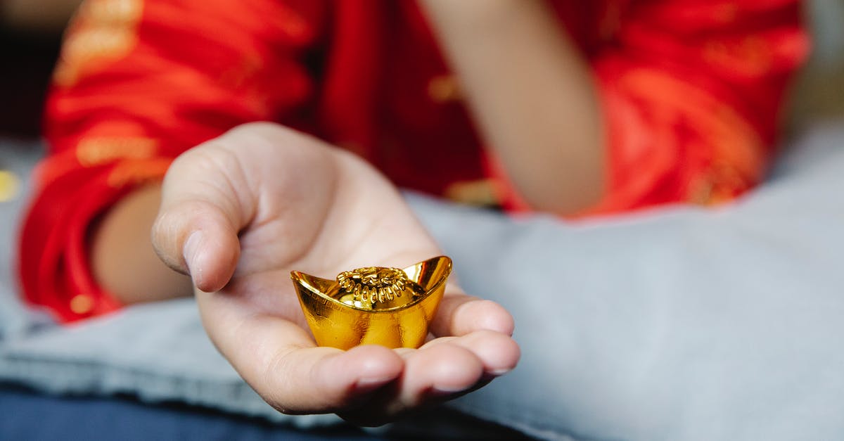 Are there any special requirements to utilize the 144 hours Chinese Transit Visa? - Crop anonymous person in authentic outfit showing Chinese gold bar presented for New Year Are there any special requirements to utilize the 144 hours Chinese Transit Visa? - Crop anonymous person in authentic outfit showing Chinese gold bar presented for New Year