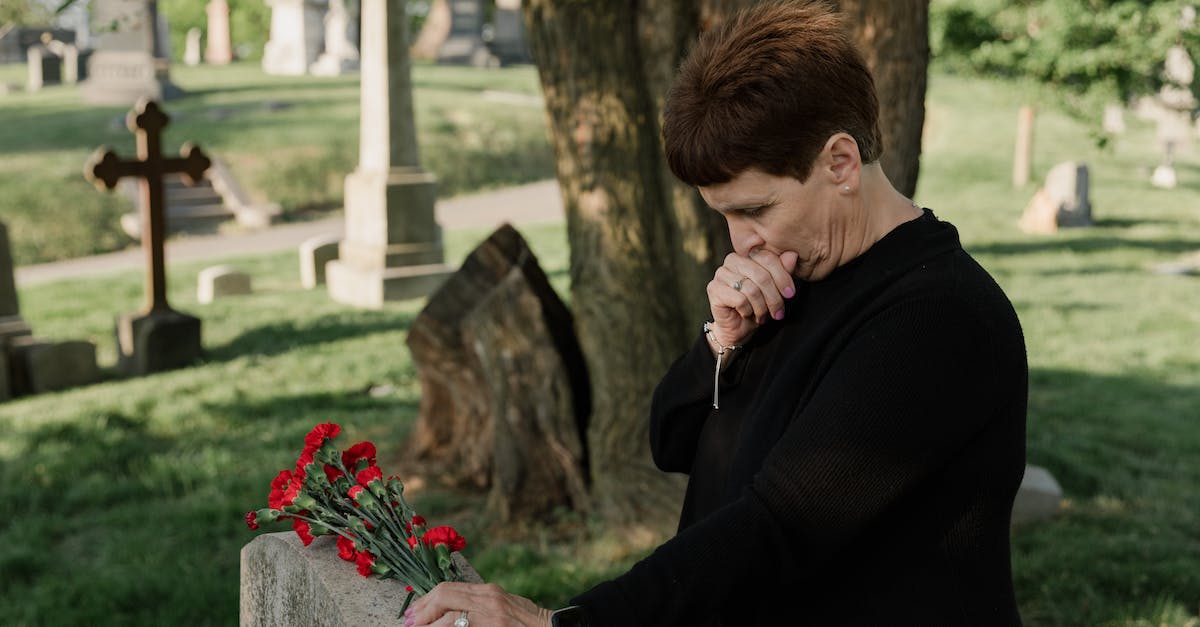 Are there any standard clothing restrictions when visiting mosques? - A Woman Holding Flowers at the Cemetery Are there any standard clothing restrictions when visiting mosques? - A Woman Holding Flowers at the Cemetery