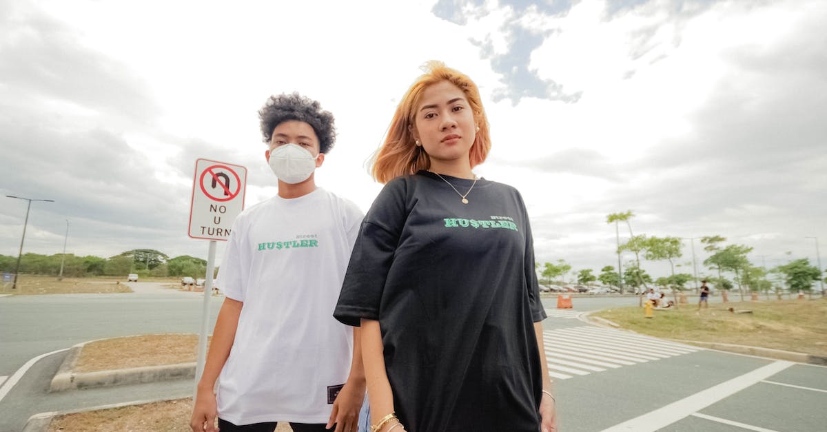 Are there any standard clothing restrictions when visiting mosques? - Man in Black Crew Neck T-shirt Standing Beside Woman in White T-shirt Are there any standard clothing restrictions when visiting mosques? - Man in Black Crew Neck T-shirt Standing Beside Woman in White T-shirt
