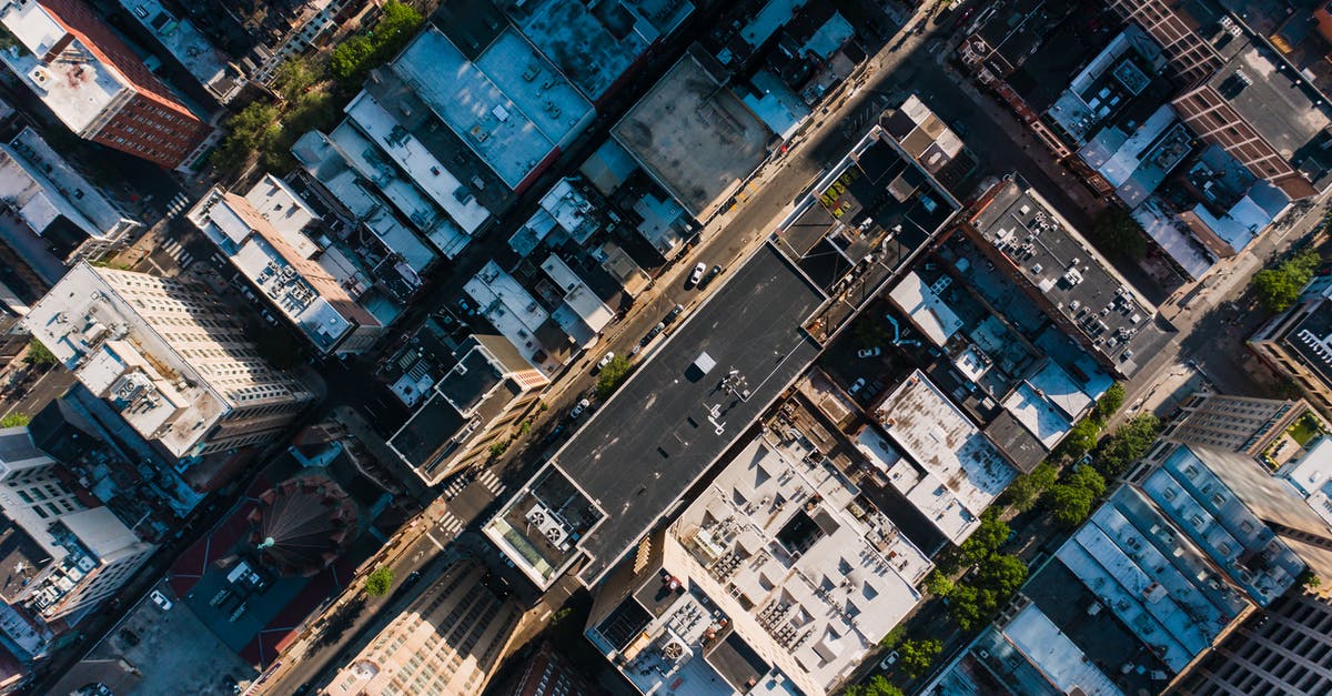 Are there any techniques, tricks, or tactics to avoid a one-way fee when renting a car? - Aerial view of typical apartment buildings with automobiles driving along road in residential district Are there any techniques, tricks, or tactics to avoid a one-way fee when renting a car? - Aerial view of typical apartment buildings with automobiles driving along road in residential district