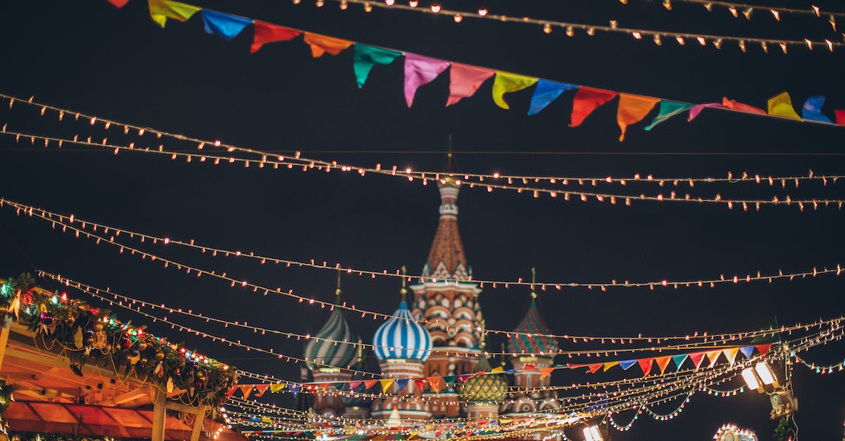 Are there Christmas markets in Switzerland? - Strings of illuminated garlands hanging over holiday market on background of majestic cathedral Are there Christmas markets in Switzerland? - Strings of illuminated garlands hanging over holiday market on background of majestic cathedral