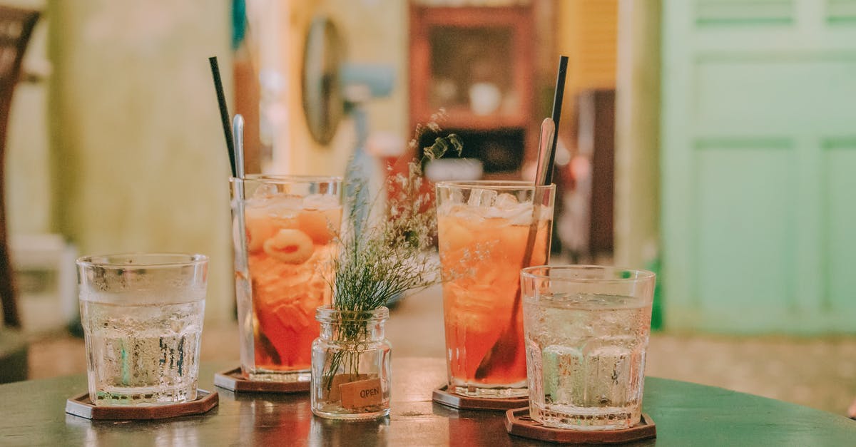 Are there Cocktail bars in London that can be booked < 4 weeks in advance? [closed] - Four Clear Glass Drinking Cups Filled With Orange and Clear Liquids on Black Surface