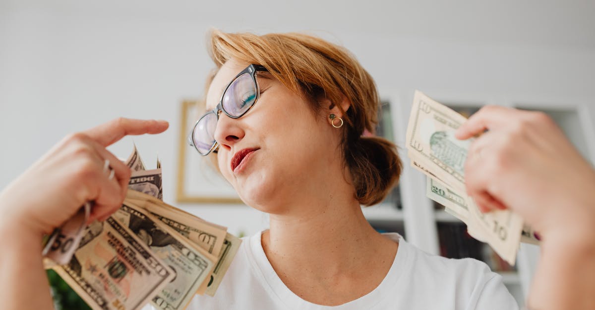 Are there countries where I shouldn't offer to shake hands with people of the opposite sex? [closed] - Woman in White Crew Neck Shirt Holding Dollar Bills