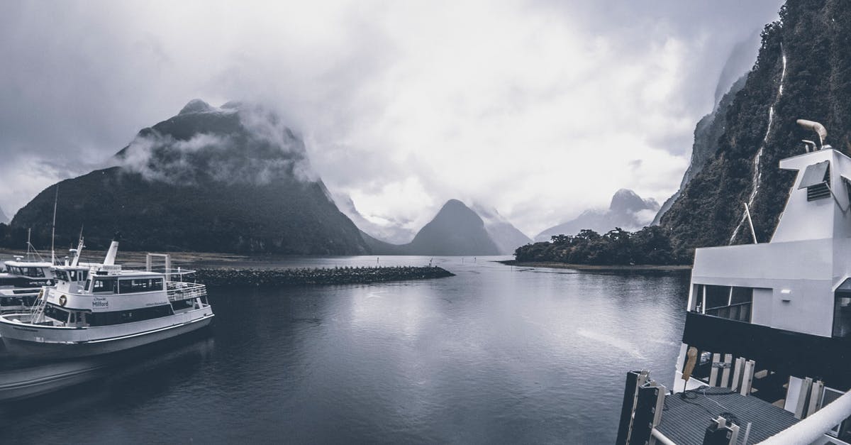 Are there guides when traveling on cruise ships between countries? - Grayscale Photo of Yachts on Body of Water Under Cloudy Sky Are there guides when traveling on cruise ships between countries? - Grayscale Photo of Yachts on Body of Water Under Cloudy Sky