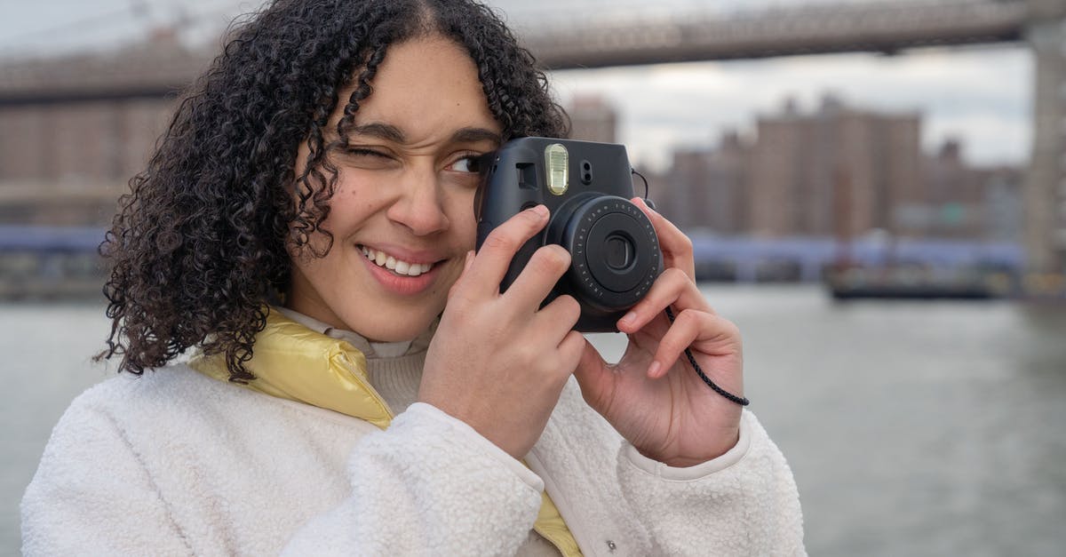Are there issues with street photography in China when using a professional camera? - Hispanic female photographer with photo camera near river and bridge Are there issues with street photography in China when using a professional camera? - Hispanic female photographer with photo camera near river and bridge