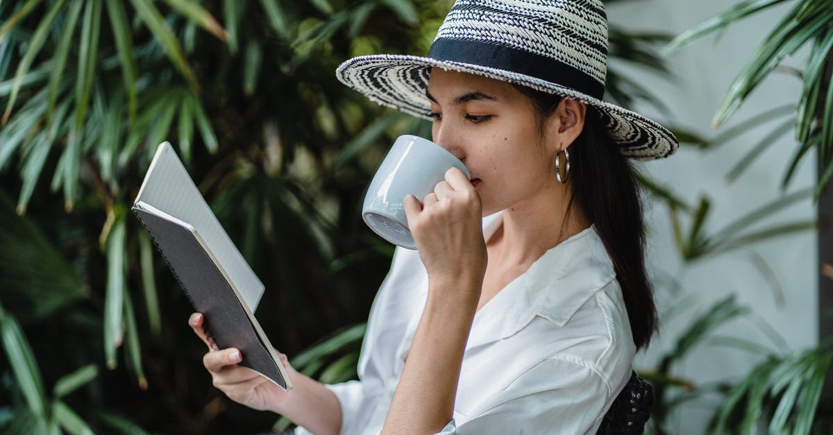 Are there long-term lockers near Istanbul's Sabiha Gökçen airport? - Young ethnic woman reading notebook while drinking beverage on chair Are there long-term lockers near Istanbul's Sabiha Gökçen airport? - Young ethnic woman reading notebook while drinking beverage on chair