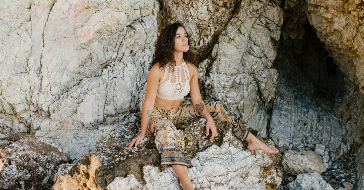Are there organized multiday cave trips in Europe? - Young thoughtful female in summer clothes having rest outside rocky cave and looking away Are there organized multiday cave trips in Europe? - Young thoughtful female in summer clothes having rest outside rocky cave and looking away