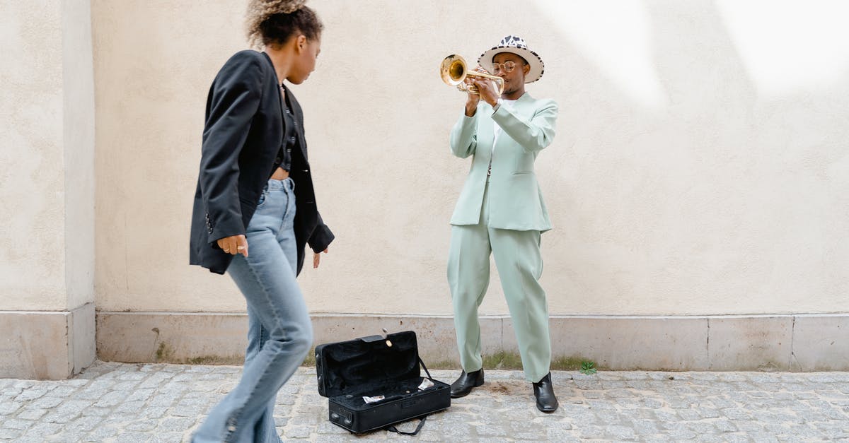 Are there people who travel continuously, but still manage to make money on the go? [duplicate] - Woman Giving Coins to the Man Playing Trumpet 