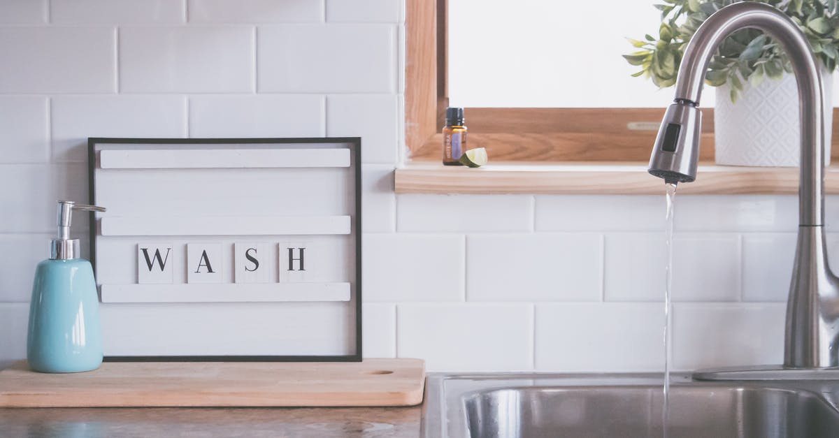 Are there public bath etiquette to be aware of in Japan for foreign women? [duplicate] - Board with word WASH placed near soap dispenser on counter in bathroom with water streaming from open faucet