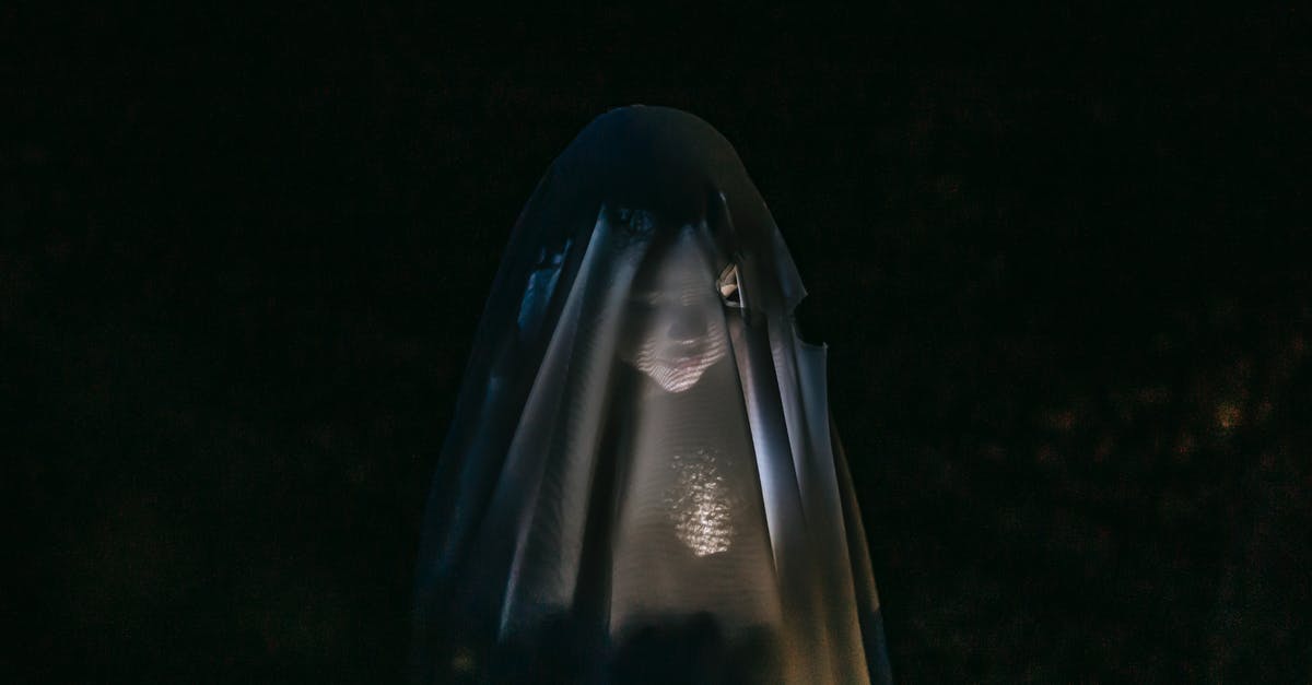Are there tips and tricks to overcome a fear of flying? - Mysterious little girl standing in darkness covered with white blanket as ghost and shining flashlight on face Are there tips and tricks to overcome a fear of flying? - Mysterious little girl standing in darkness covered with white blanket as ghost and shining flashlight on face