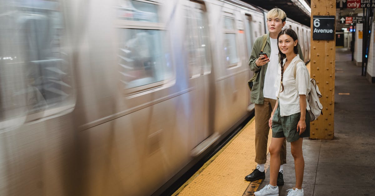 Are there wisteria tunnels close to Tokyo? - Young trendy ethnic passengers waiting for train on platform Are there wisteria tunnels close to Tokyo? - Young trendy ethnic passengers waiting for train on platform