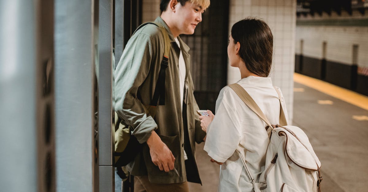 Are there wisteria tunnels close to Tokyo? - Stylish young ethnic couple entering underground station Are there wisteria tunnels close to Tokyo? - Stylish young ethnic couple entering underground station