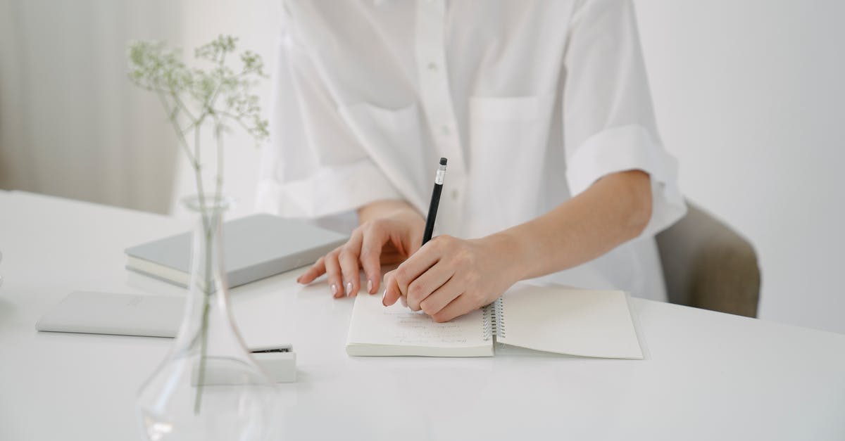 Are these common pencil case items allowed on a flight inside the EU? - Crop person writing in notebook at table Are these common pencil case items allowed on a flight inside the EU? - Crop person writing in notebook at table