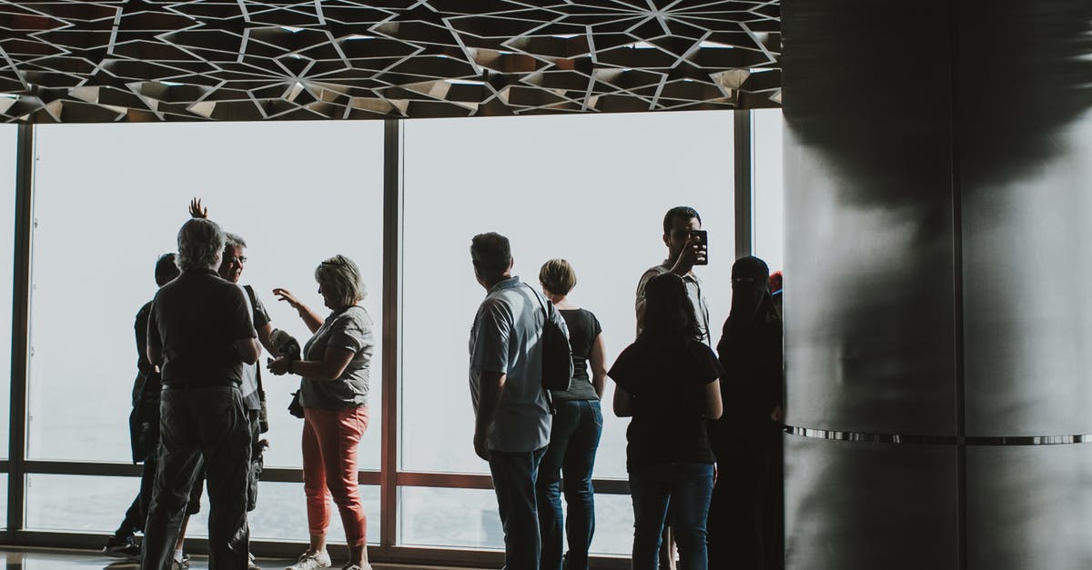 Are visitors allowed in Dubai Airport? - Group of People Standing on White Floor Are visitors allowed in Dubai Airport? - Group of People Standing on White Floor