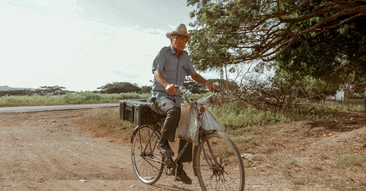 Are ziploc bags banned in Rwanda for air travelers? - Elderly male in hat riding bike on dry roadway and looking at camera under cloudy sky Are ziploc bags banned in Rwanda for air travelers? - Elderly male in hat riding bike on dry roadway and looking at camera under cloudy sky