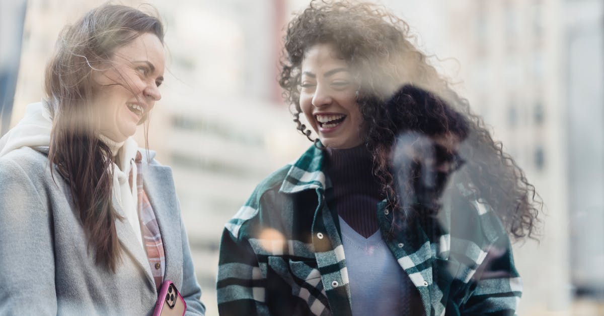 Arriving at Newark from Europe, have ESTA, how long should it take to go through immigration and customs? - Laughing women having conversation on street Arriving at Newark from Europe, have ESTA, how long should it take to go through immigration and customs? - Laughing women having conversation on street