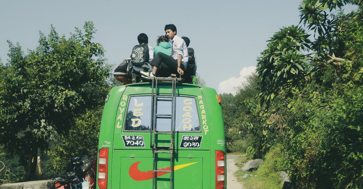 At *some* border crossings, why do bus passengers have to get off, but not those in cars? - Man in Black Jacket Sitting on Green Van At *some* border crossings, why do bus passengers have to get off, but not those in cars? - Man in Black Jacket Sitting on Green Van