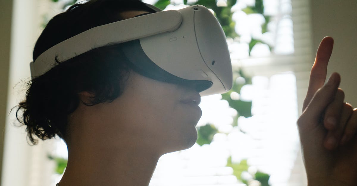 Augmented reality app to identify what's around you - Amazed young guy exploring cyberspace in VR headset Augmented reality app to identify what's around you - Amazed young guy exploring cyberspace in VR headset