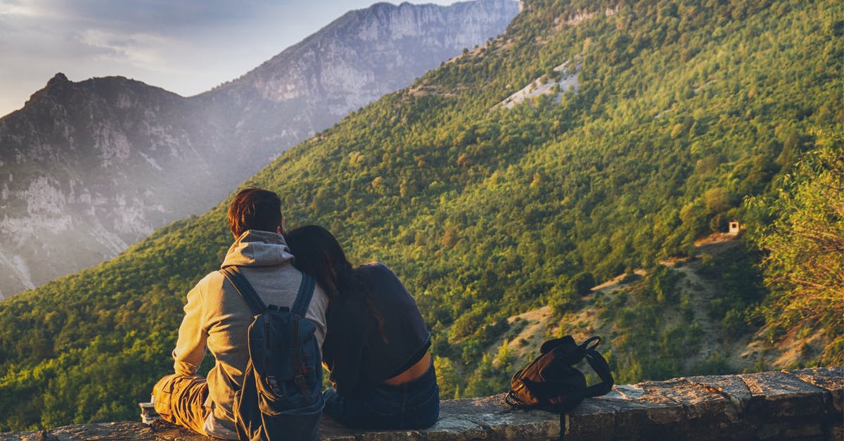 Australian and British defacto couple travelling in the EU - Couples Sitting in While Facing Mountain Australian and British defacto couple travelling in the EU - Couples Sitting in While Facing Mountain