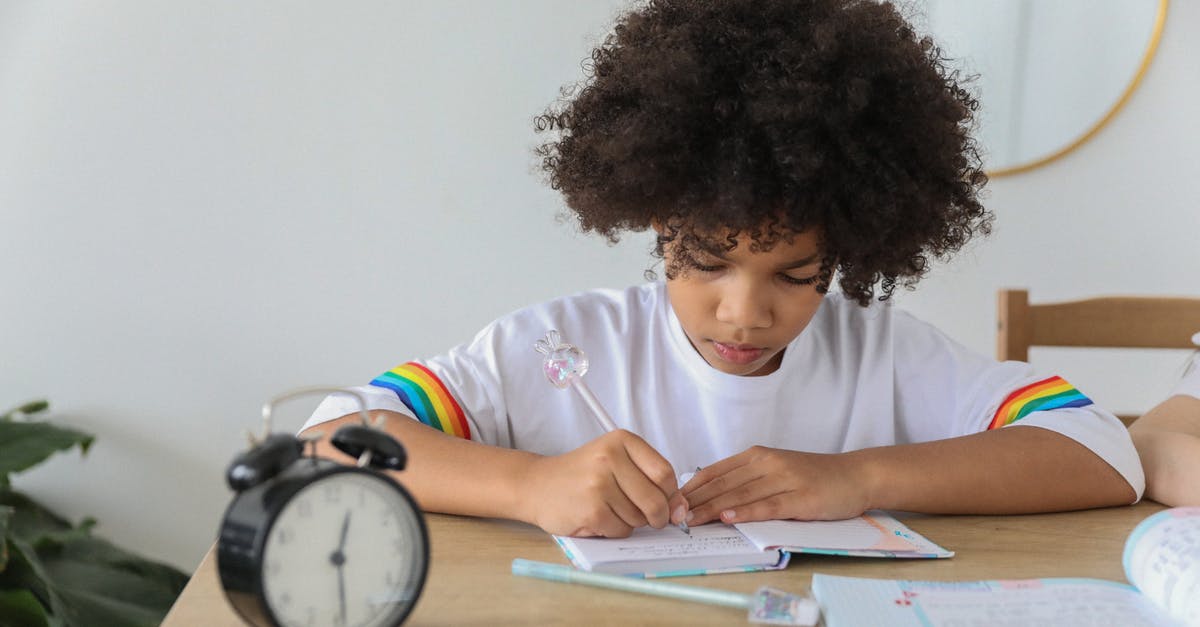 Australian passport processing time overseas - Concentrated African American child writing in notebook while studying at desk with alarm clock at home Australian passport processing time overseas - Concentrated African American child writing in notebook while studying at desk with alarm clock at home