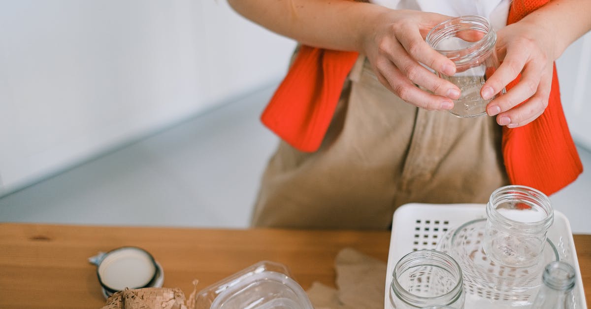 Australian visa -Global processing time is exceeded but no response from consultate? - Crop anonymous female in casual clothes standing with glass jar near table while sorting out paper plastic and glass rubbish for recycling