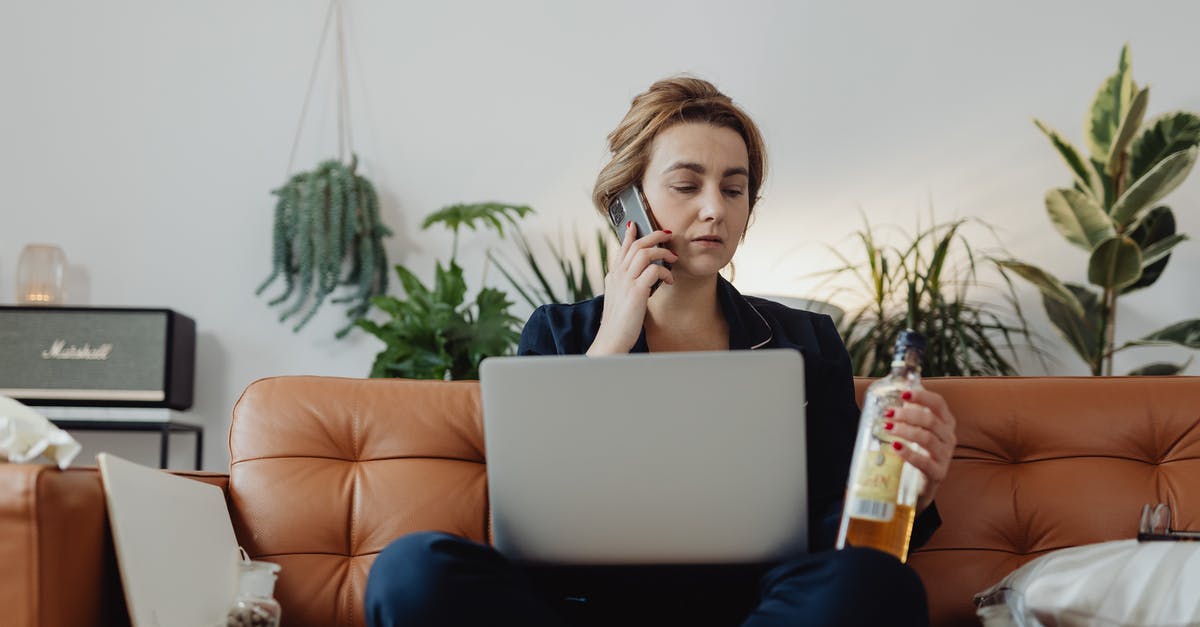 Availability of alcohol in Morocco? - Woman Talking on the Phone and Holding a Bottle of Liquor Availability of alcohol in Morocco? - Woman Talking on the Phone and Holding a Bottle of Liquor