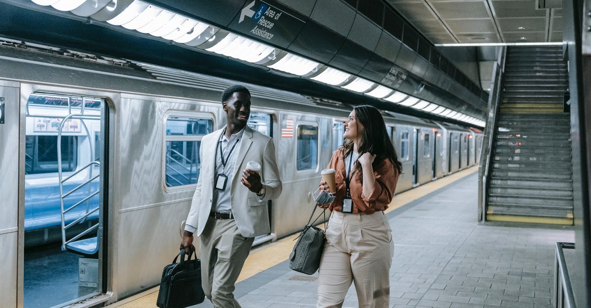 Avoid long walking when changing between Tokyo subway lines - A Man and Woman Walking Near the Train while Having Conversation Avoid long walking when changing between Tokyo subway lines - A Man and Woman Walking Near the Train while Having Conversation