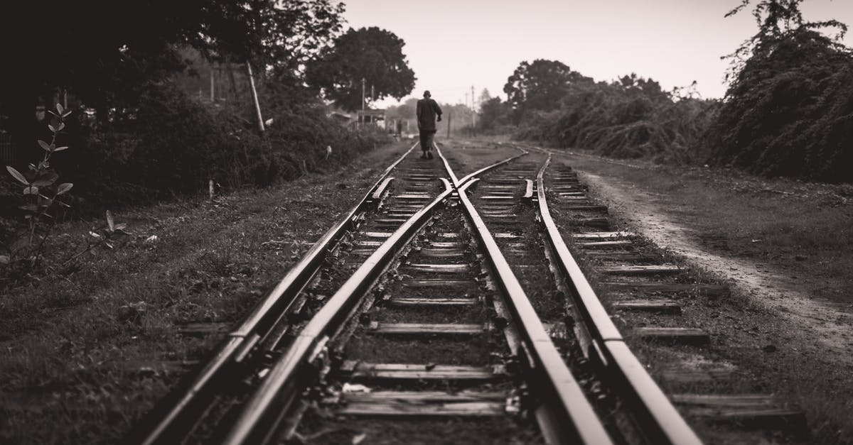 Avoid long walking when changing between Tokyo subway lines - Grayscale Photo of a Person Walking on Railway Track Avoid long walking when changing between Tokyo subway lines - Grayscale Photo of a Person Walking on Railway Track