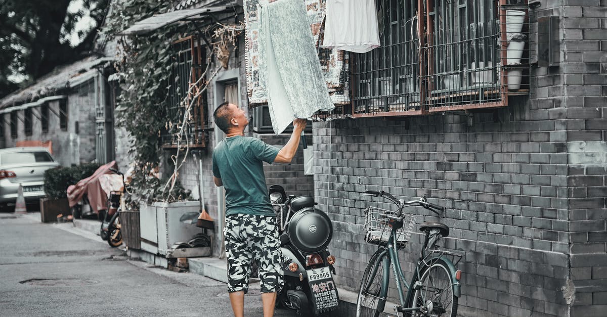 Avoiding human trafficking when getting a massage in Japan - Man Getting the Towel In Front of a House Avoiding human trafficking when getting a massage in Japan - Man Getting the Towel In Front of a House