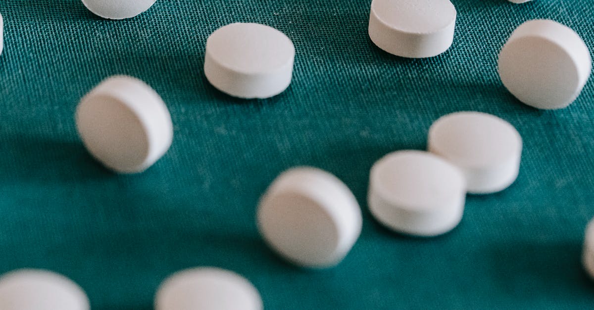 B1/B2 visa. Why did I have to sign a form after a random search? [closed] - Closeup of similar round white pills spilled on green tissue in random order