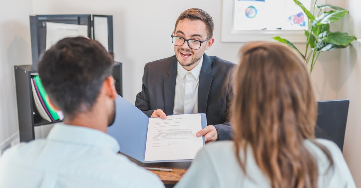 B-1/B-2 Visa Working with US clients - A Broker Showing a Couple the Mortgage Contract B-1/B-2 Visa Working with US clients - A Broker Showing a Couple the Mortgage Contract