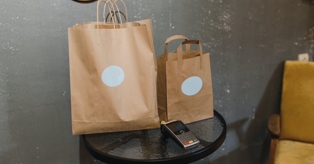 bags and wheelchair - Brown Paper Bag on Round Black Table bags and wheelchair - Brown Paper Bag on Round Black Table