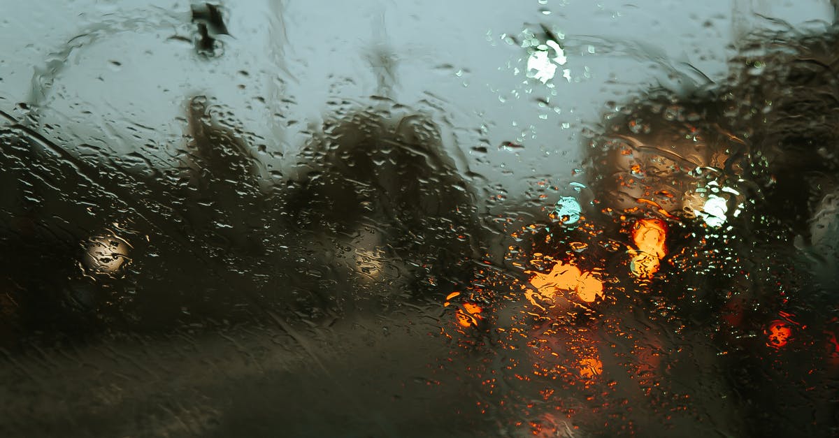 Bangalore to Tiruvannamalai : Even, asphalt road - Road in modern city street with lights through car window in rainy weather Bangalore to Tiruvannamalai : Even, asphalt road - Road in modern city street with lights through car window in rainy weather