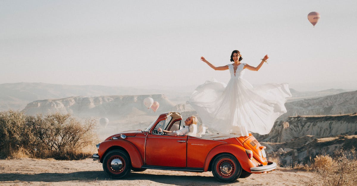 Become a travel agent just for yourself to get deals - Woman Standing on Volkswagen Beetle Become a travel agent just for yourself to get deals - Woman Standing on Volkswagen Beetle