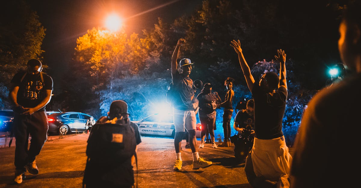 Being a tourist, can I film police in the US? - Black men standing on street near journalists and police car during anti racism demonstration Being a tourist, can I film police in the US? - Black men standing on street near journalists and police car during anti racism demonstration