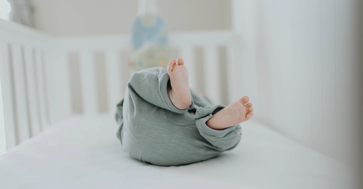 Below standard baby crib - Close-up Photo of Baby Wearing Gray Pants Below standard baby crib - Close-up Photo of Baby Wearing Gray Pants