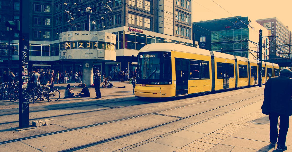 Berlin to Göttingen by Train or Bus - Selective Color Photography of Yellow Train Near Concrete Buildings Berlin to Göttingen by Train or Bus - Selective Color Photography of Yellow Train Near Concrete Buildings